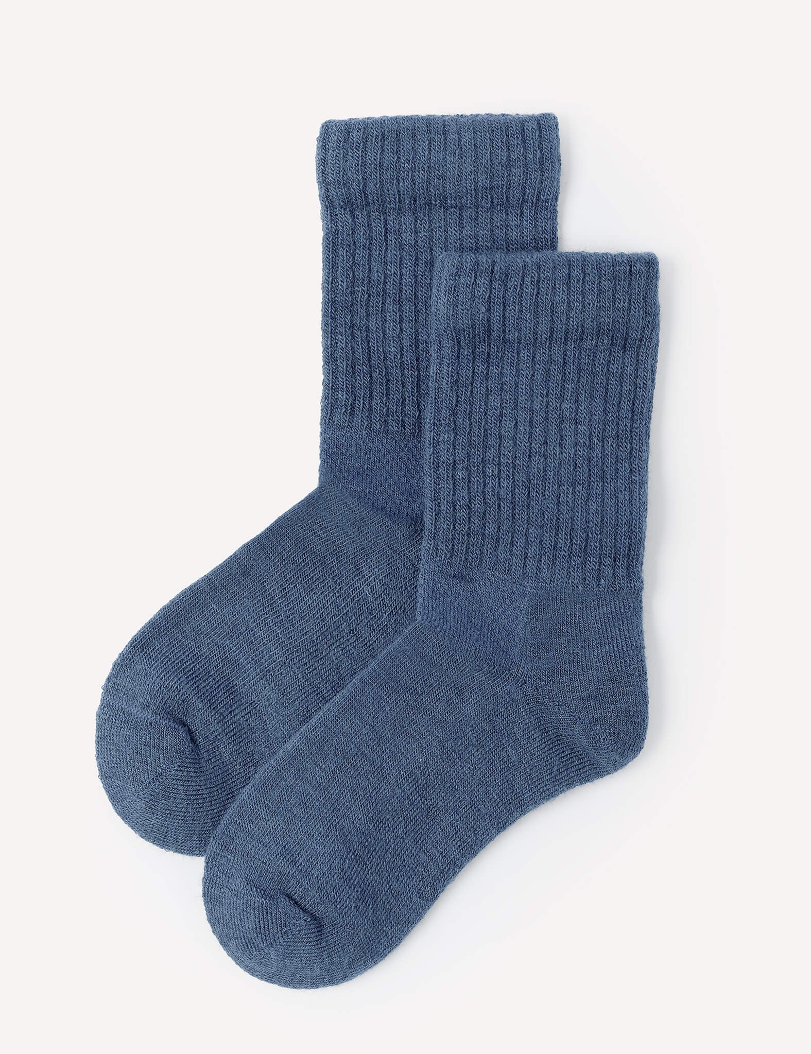 A pair of Terry Socks – Merino Kids in Ensign Blue are laid flat on a white background, with one sock slightly overlapping the other.