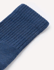 Close-up of the ribbed cuff of a Terry Socks – Merino Kids in blue, shown against a plain white background.