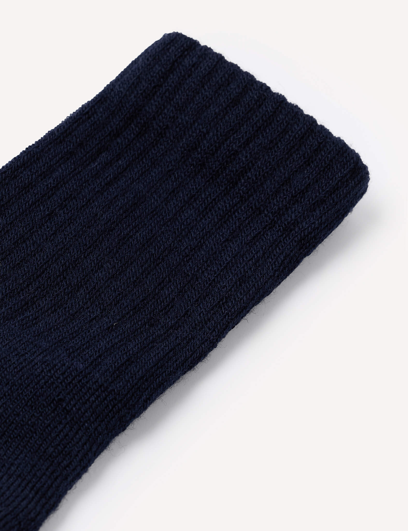 Close-up of the Terry Socks – Merino Kids in dark navy blue on a plain white background, showcasing the ribbed texture and knit pattern characteristic of merino wool terry socks.