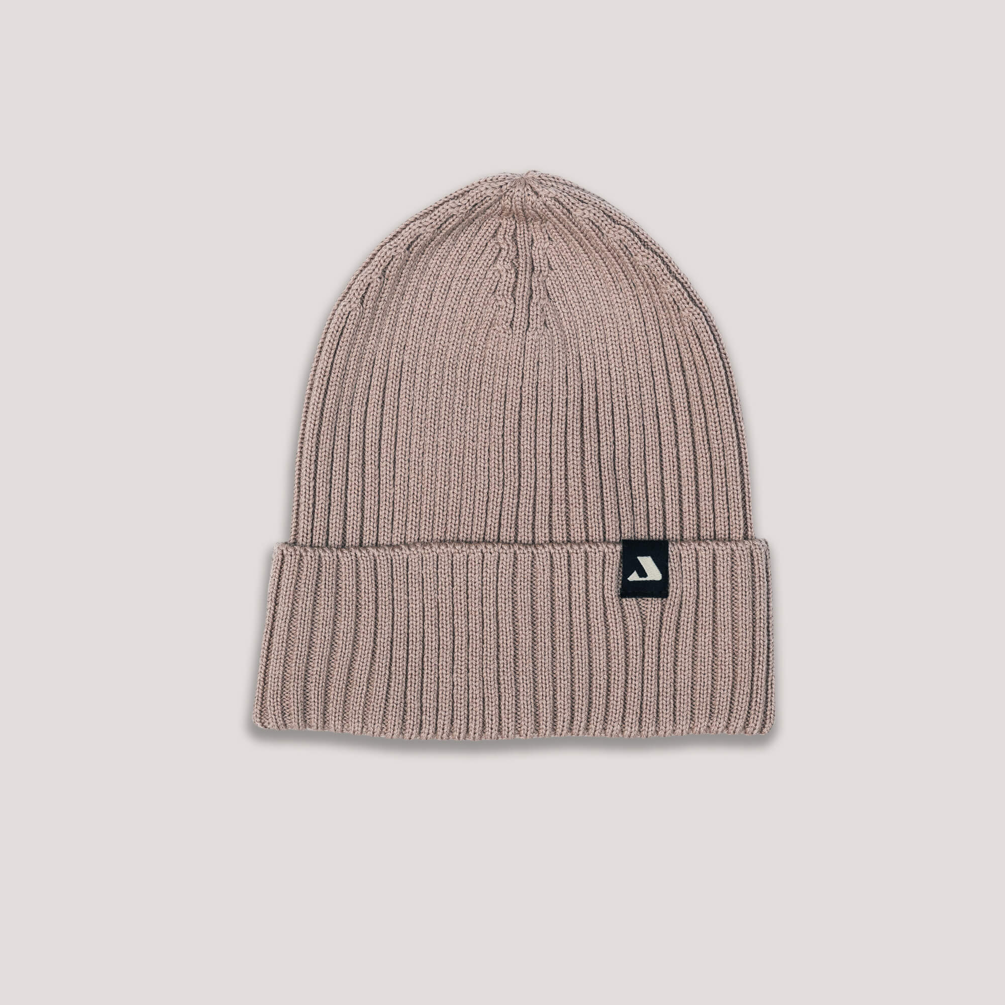 Beige knit beanie with Janus Wool logo on a light gray background