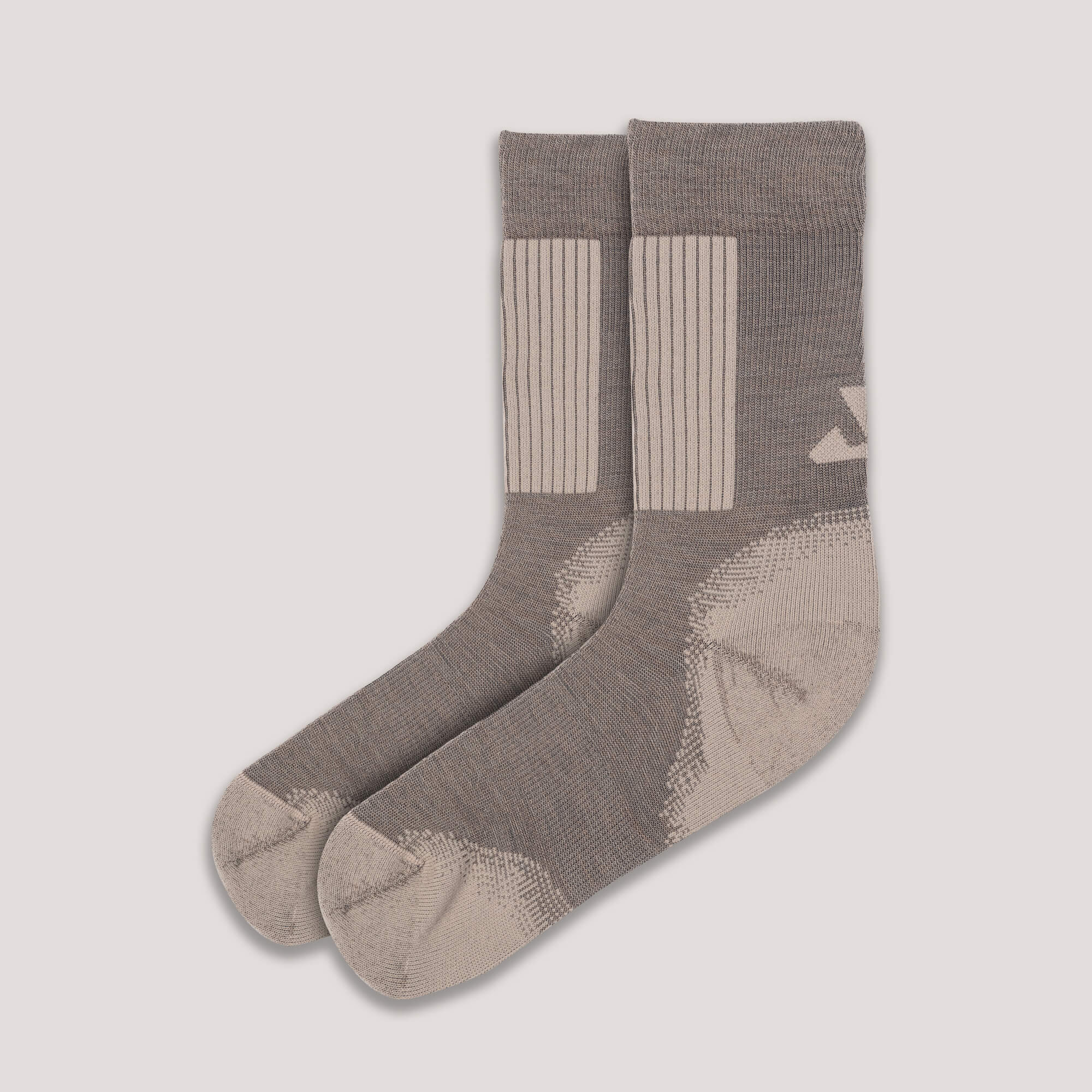 A pair of beige Socks Merino – Hiking with ribbed cuffs and geometric side patterns, designed for hiking and comfort, displayed on a plain light background.