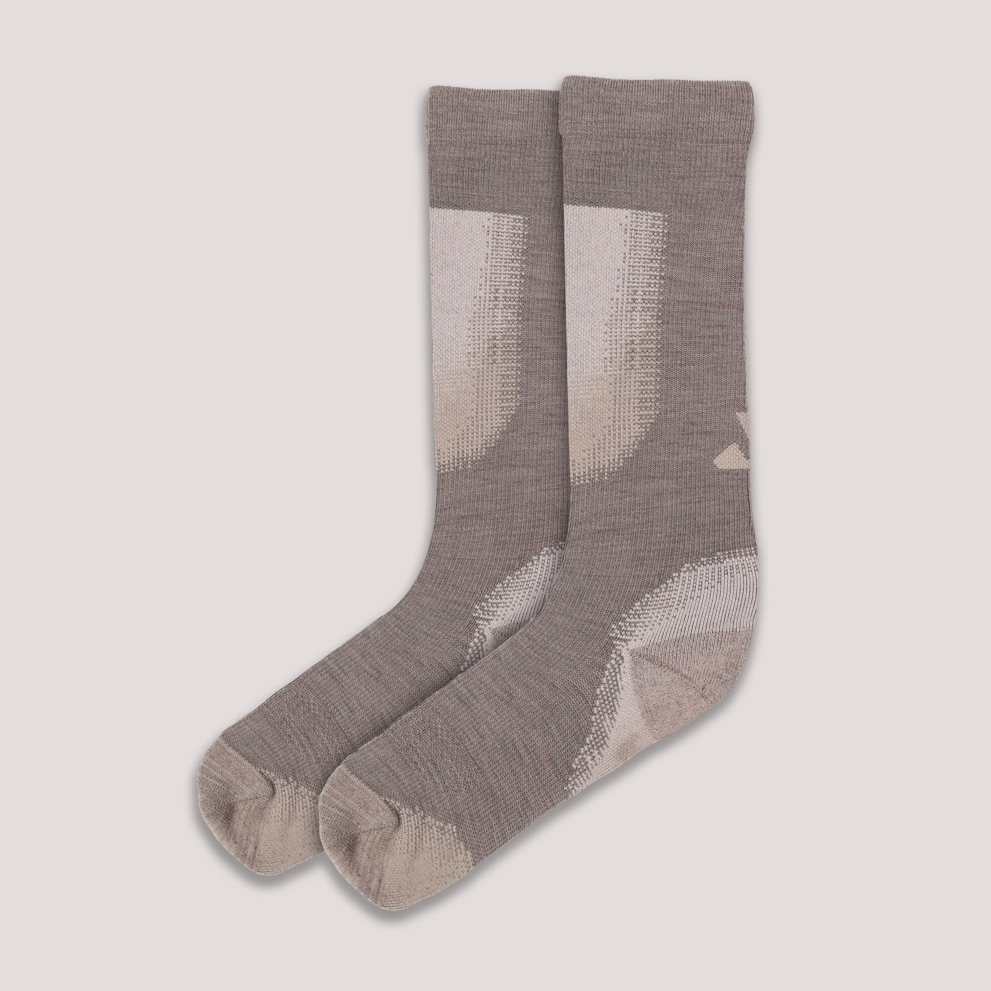 Pair of gray Janus cross-country ski socks on a light gray background