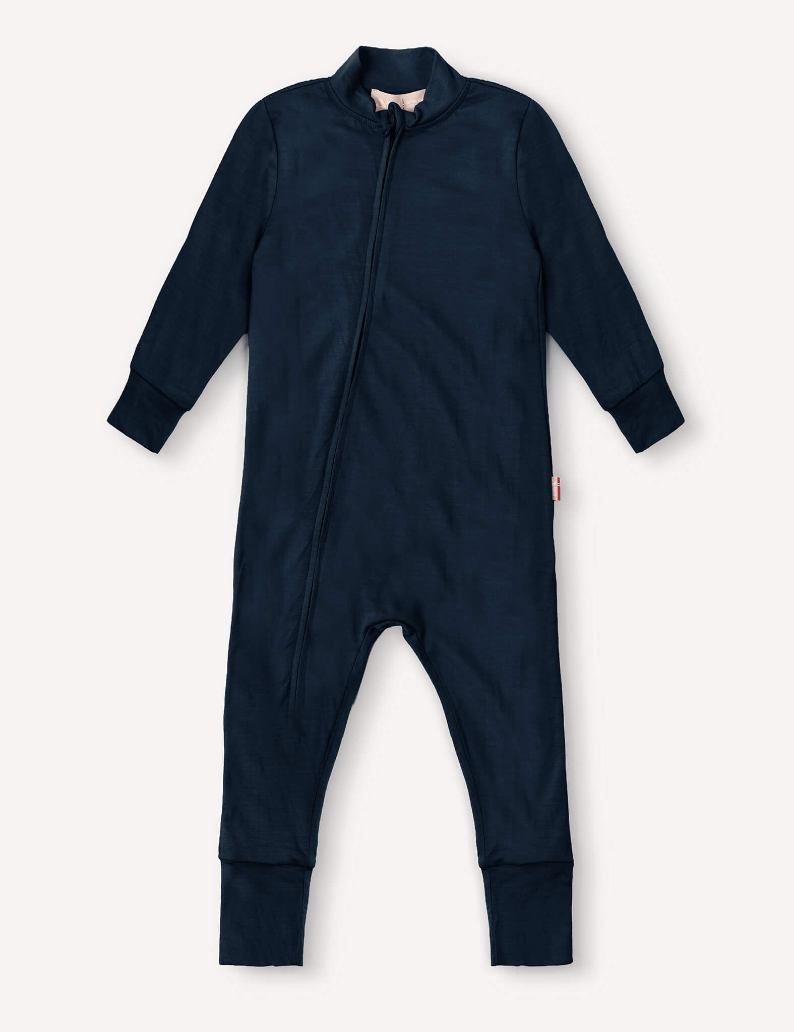Navy Pyjamas – Merino Baby Light, a long-sleeved baby onesie with full-length legs, front zipper closure, and cuffed sleeves and feet, laid flat on a light background. Crafted from breathable nightwear fabric for extra comfort.