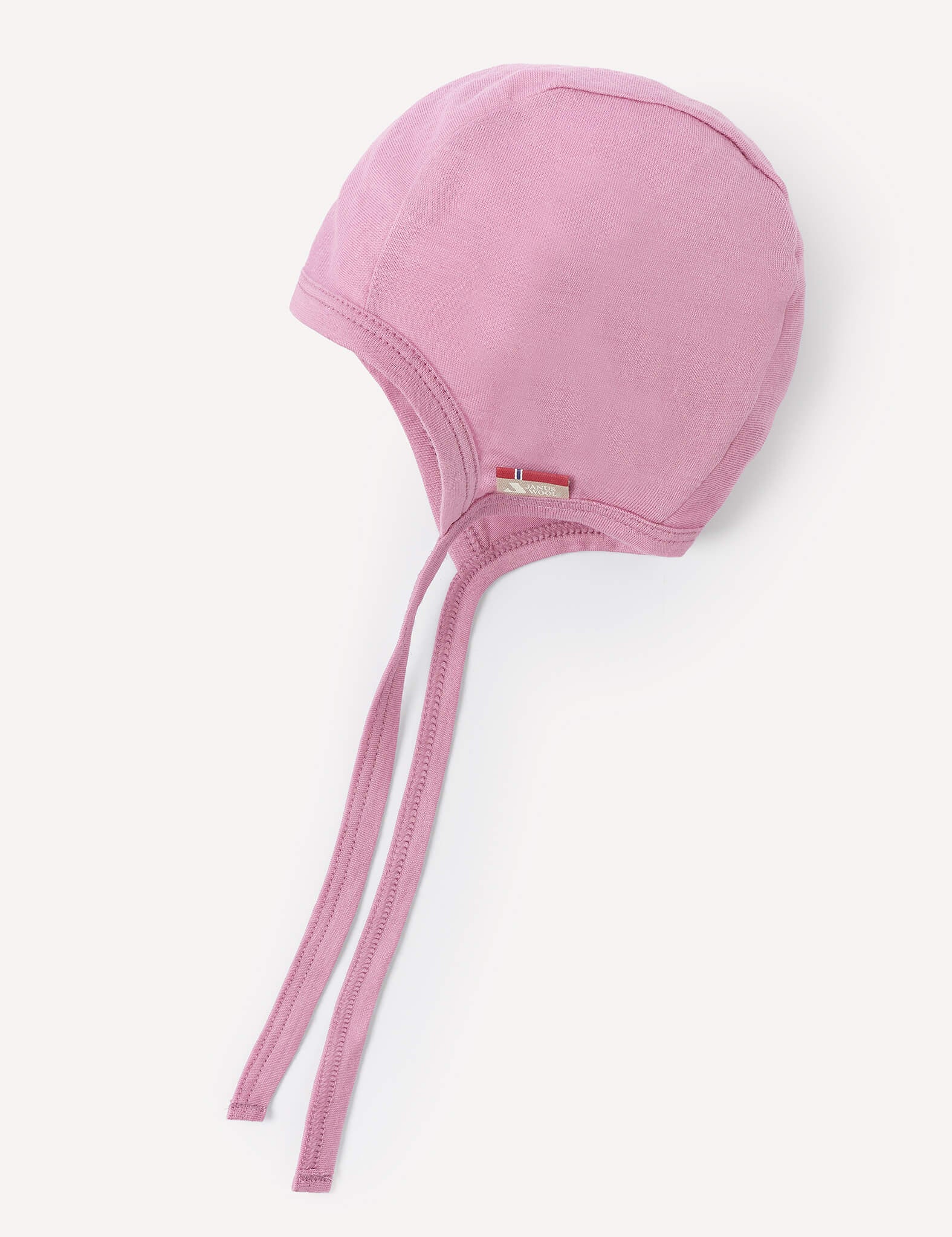 A Mauve Orchid Bonnet – Merino Baby Light, featuring two long ties and crafted from soft, breathable fabric, is displayed against a white background.