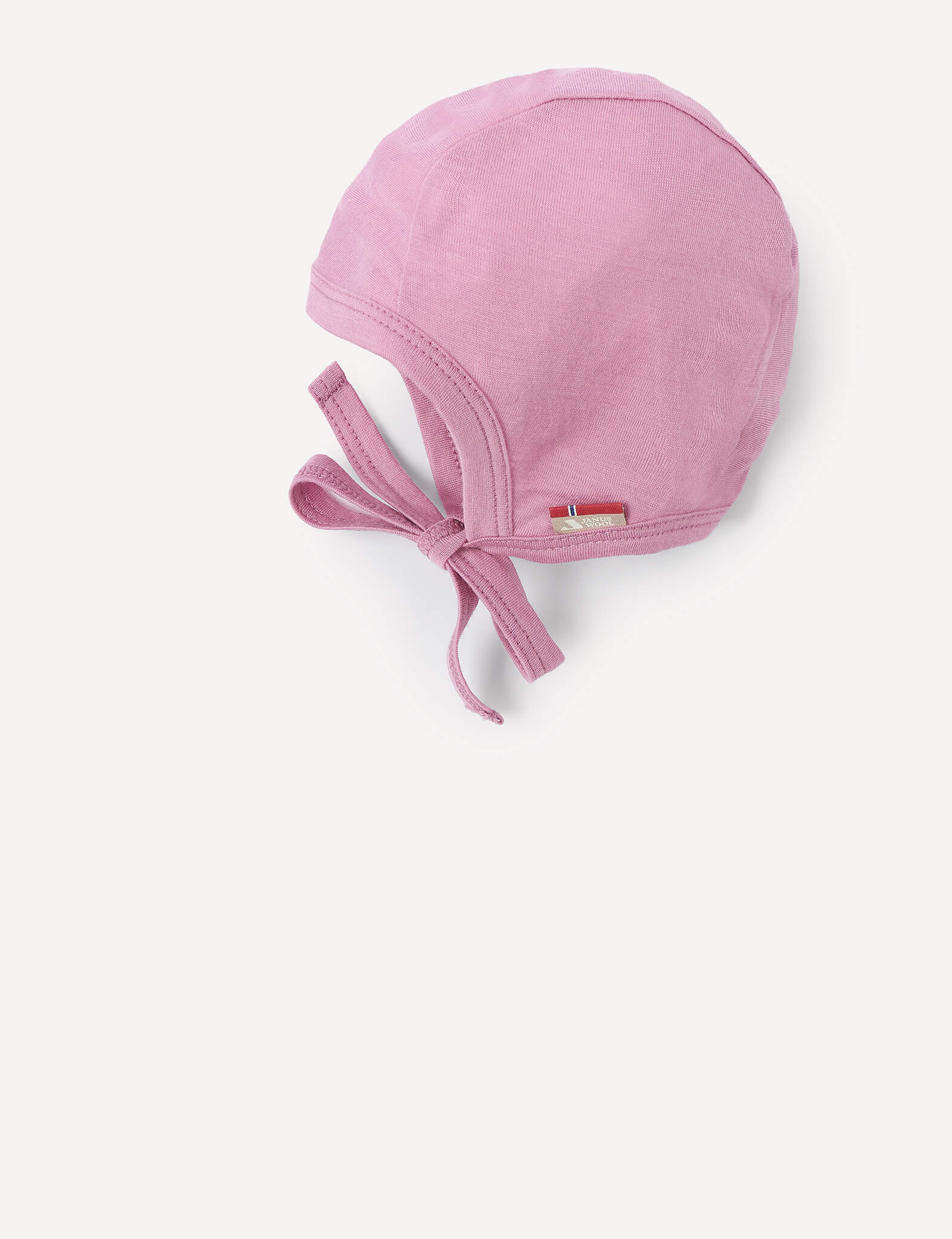 A light pink Merino Baby Light bonnet made of soft, breathable merino wool, featuring a rounded crown and lightweight chin ties, displayed against a plain white background.