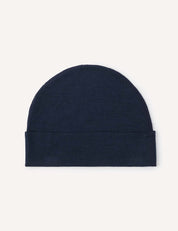 A Beanie – Merino Baby Light in plain dark blue, featuring a lightweight design and folded bottom, displayed flat against a light background.