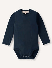 Navy Body – Merino Baby Light featuring long sleeves, a round neck, and convenient snap closures at the bottom, crafted as breathable baby clothing and displayed on a plain light background.