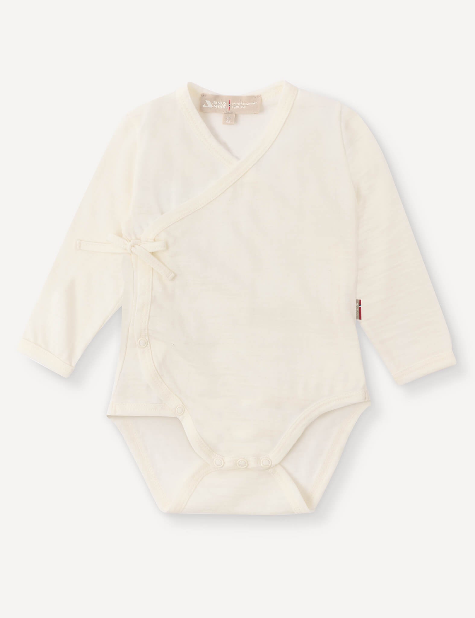 Wrapover Bodysuit – Merino Baby Light in Marshmallow, featuring long sleeves, a side tie, and snap buttons at the bottom, laid flat on a white background.