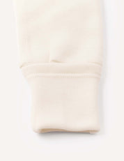Close-up of the sleeve cuff on the Onesie – Merino Baby AirWool, highlighting the fold-over design and ribbed fabric at the end, along with smooth stitching details.