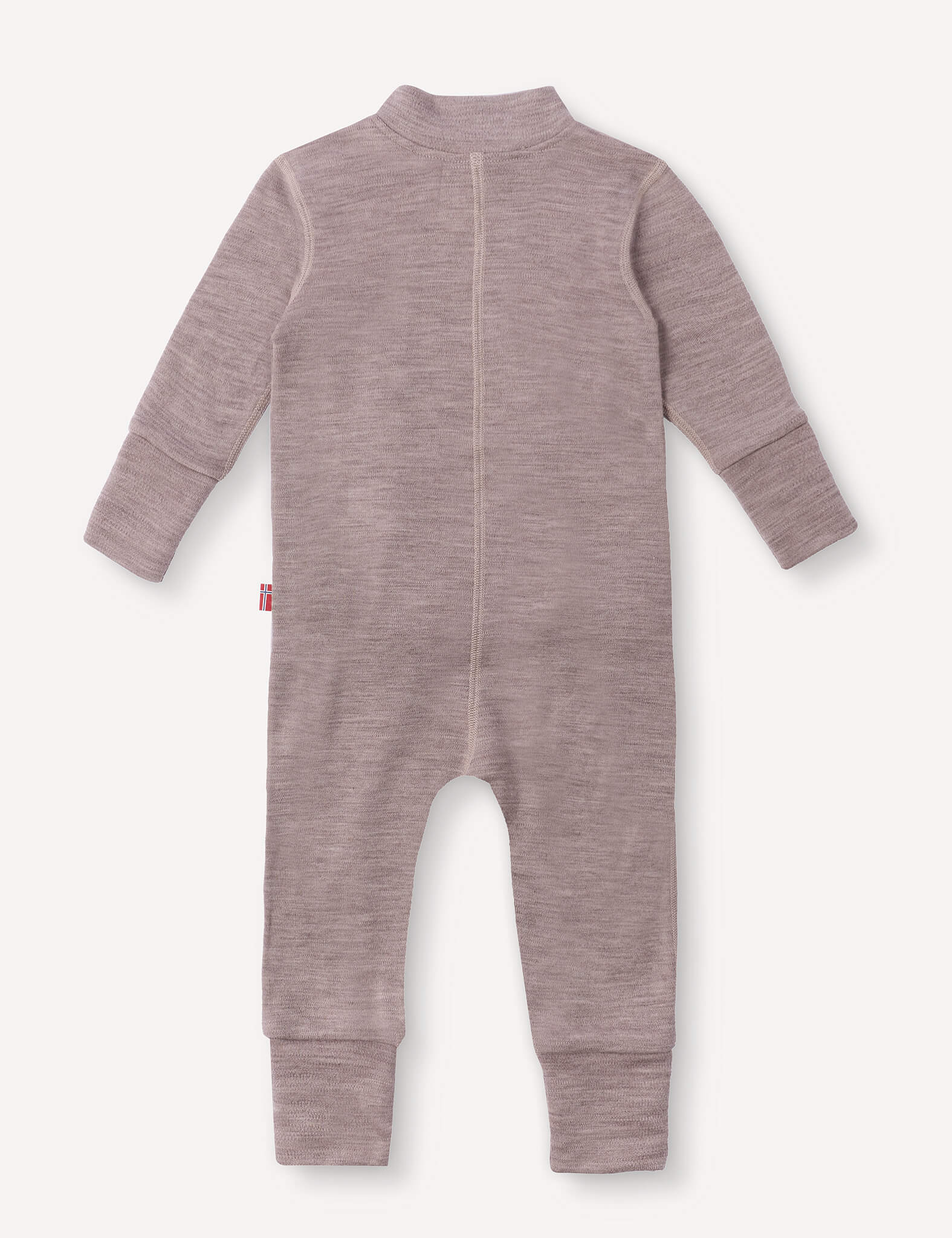 The Onesie – Merino Baby AirWool in light brown is displayed flat with the back side facing up. This long-sleeve baby onesie features a closed back seam, ribbed cuffs at the wrists and ankles, and a small red tag on the left side.