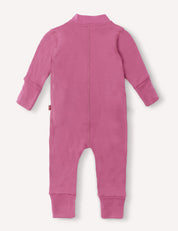 A footless, long-sleeve pink Onesie – Merino Baby AirWool is laid flat with the back side facing up, highlighting a visible center seam and ribbed cuffs at the wrists and ankles.