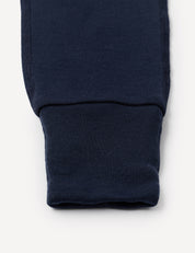 A close-up of the cuff of a Onesie – Merino Baby AirWool, showing ribbed, fold-over cuffs at the ankle.