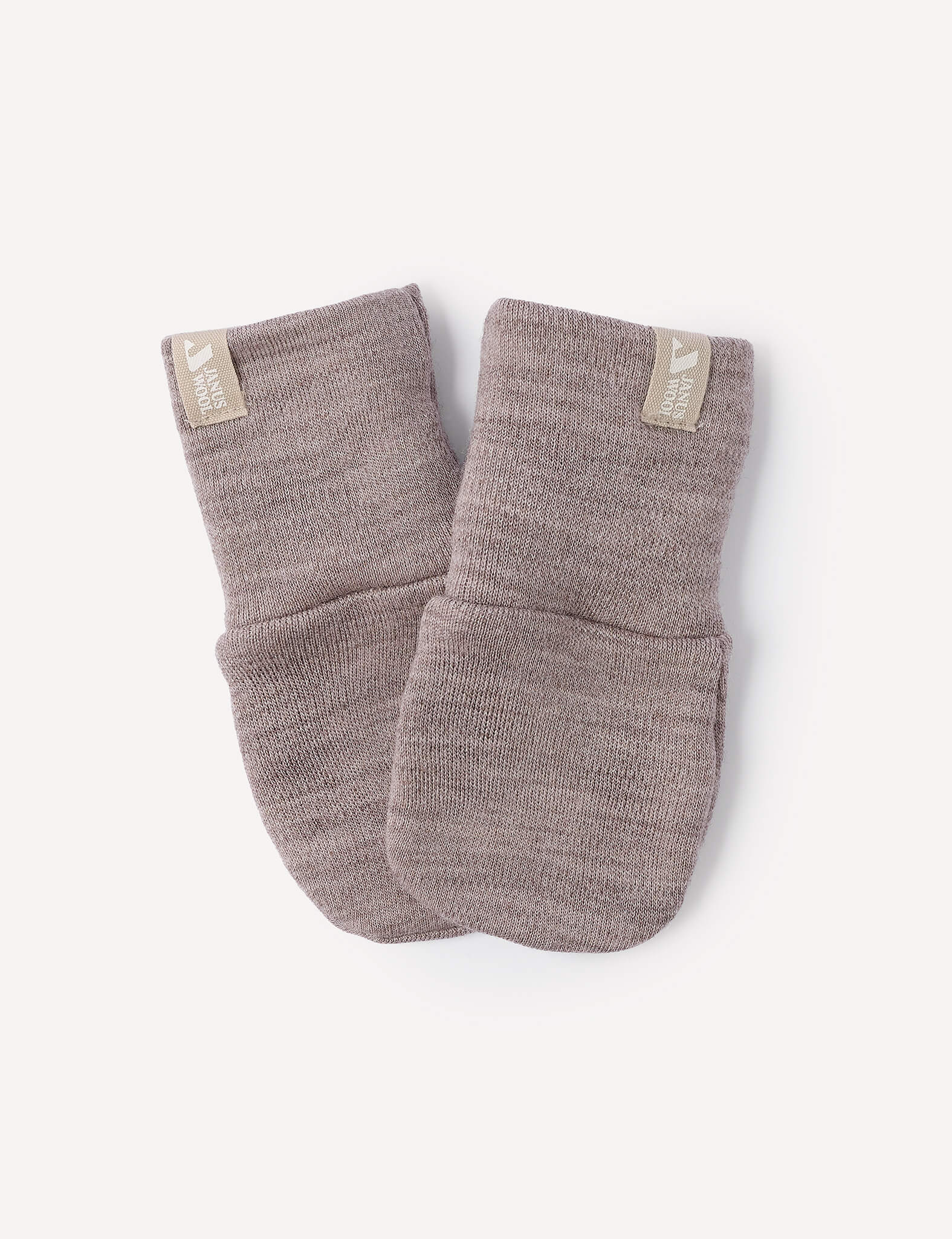 A pair of Beige Melange Mittens – Merino Baby AirWool, crafted from soft merino wool with a knit texture, featuring folded cuffs and small cream-colored fabric tags on each cuff, are positioned side by side on a plain white background.
