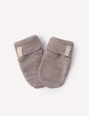 A pair of Mittens – Merino Baby AirWool in soft, light brown merino wool with folded cuffs and a small fabric label on each cuff, displayed on a plain white background.