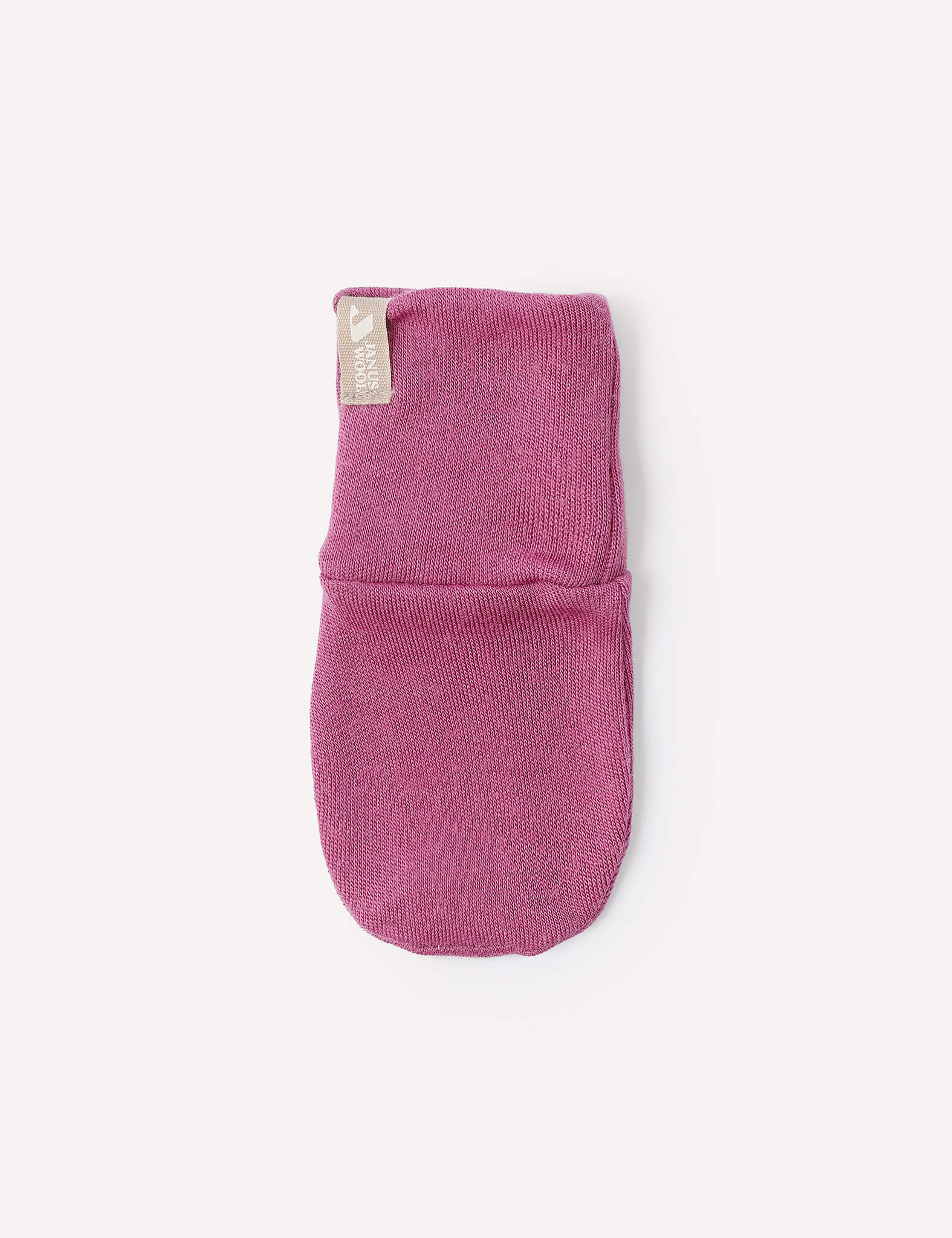 A single Mittens – Merino Baby AirWool in pink, featuring a small beige tag, is displayed on a plain white background.