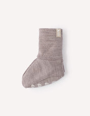 A single Booties – Merino Baby AirWool in light brown, featuring a folded cuff and non-slip white grips on the sole, displayed against a plain white background.
