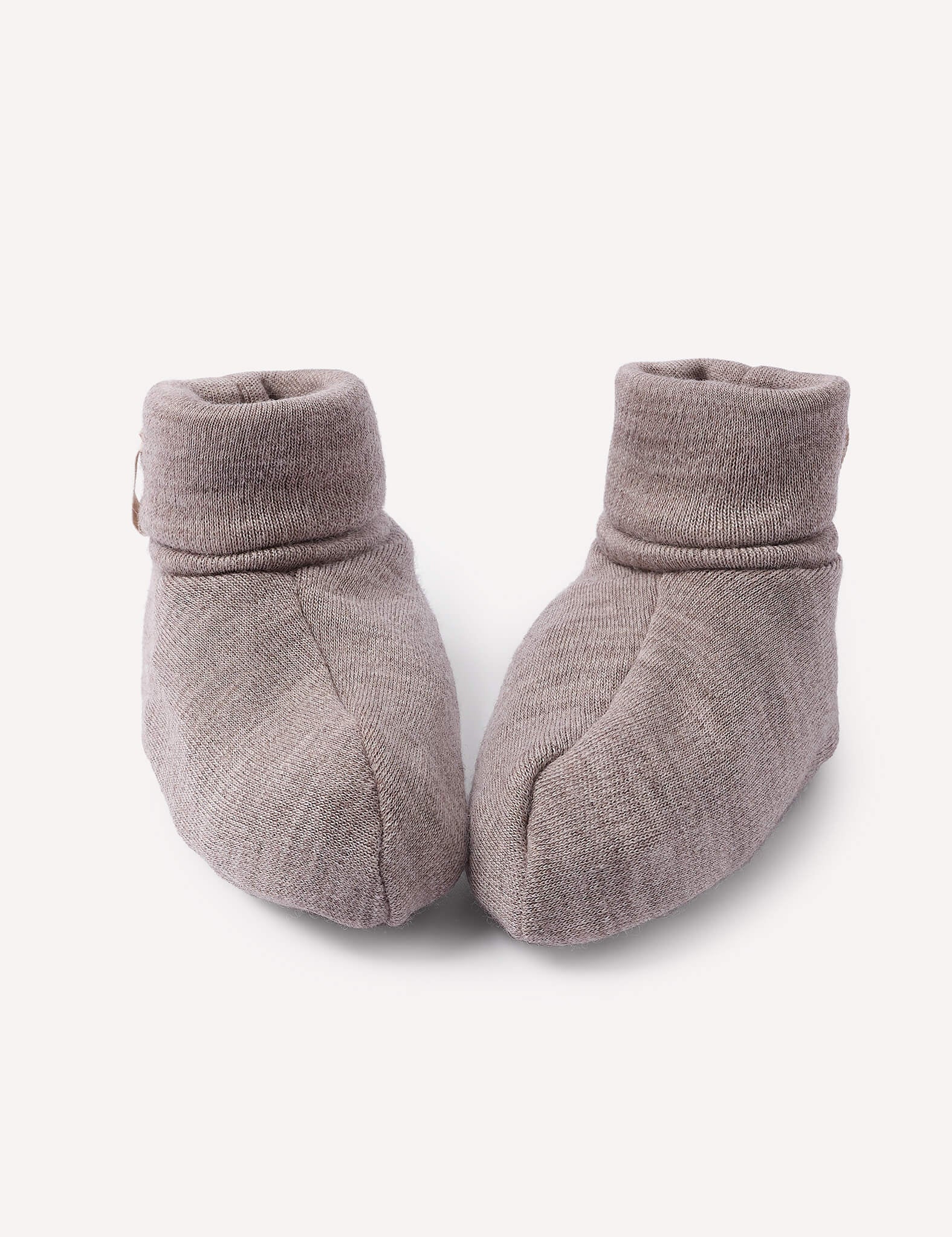 A pair of Booties – Merino Baby AirWool in Beige Melange are placed side by side on a plain white background.