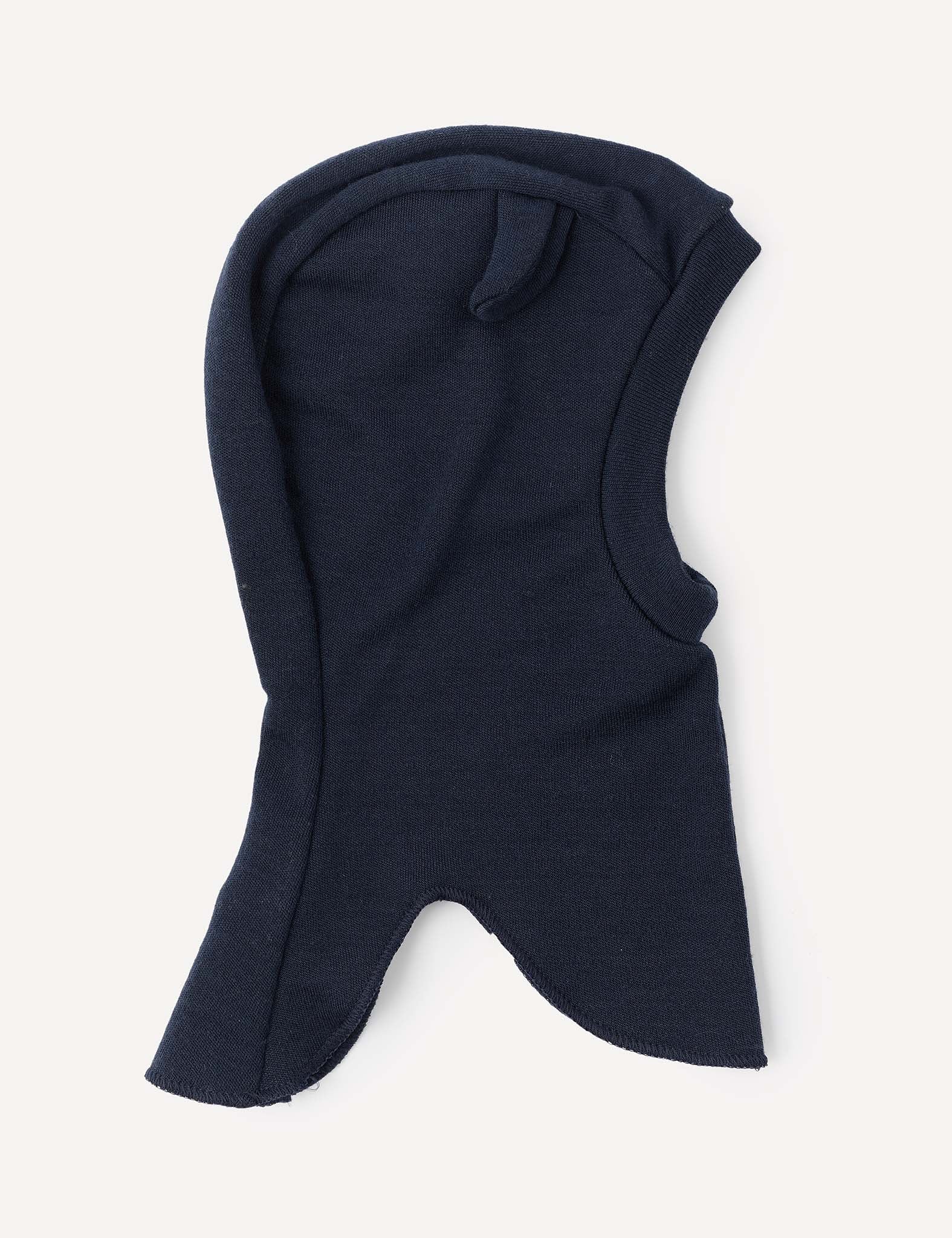 The Balaclava – Merino Baby AirWool in Navy is laid flat against a light background, highlighting its simple, smooth merino wool fabric and open face design with a pointed bottom edge for breathable insulation.