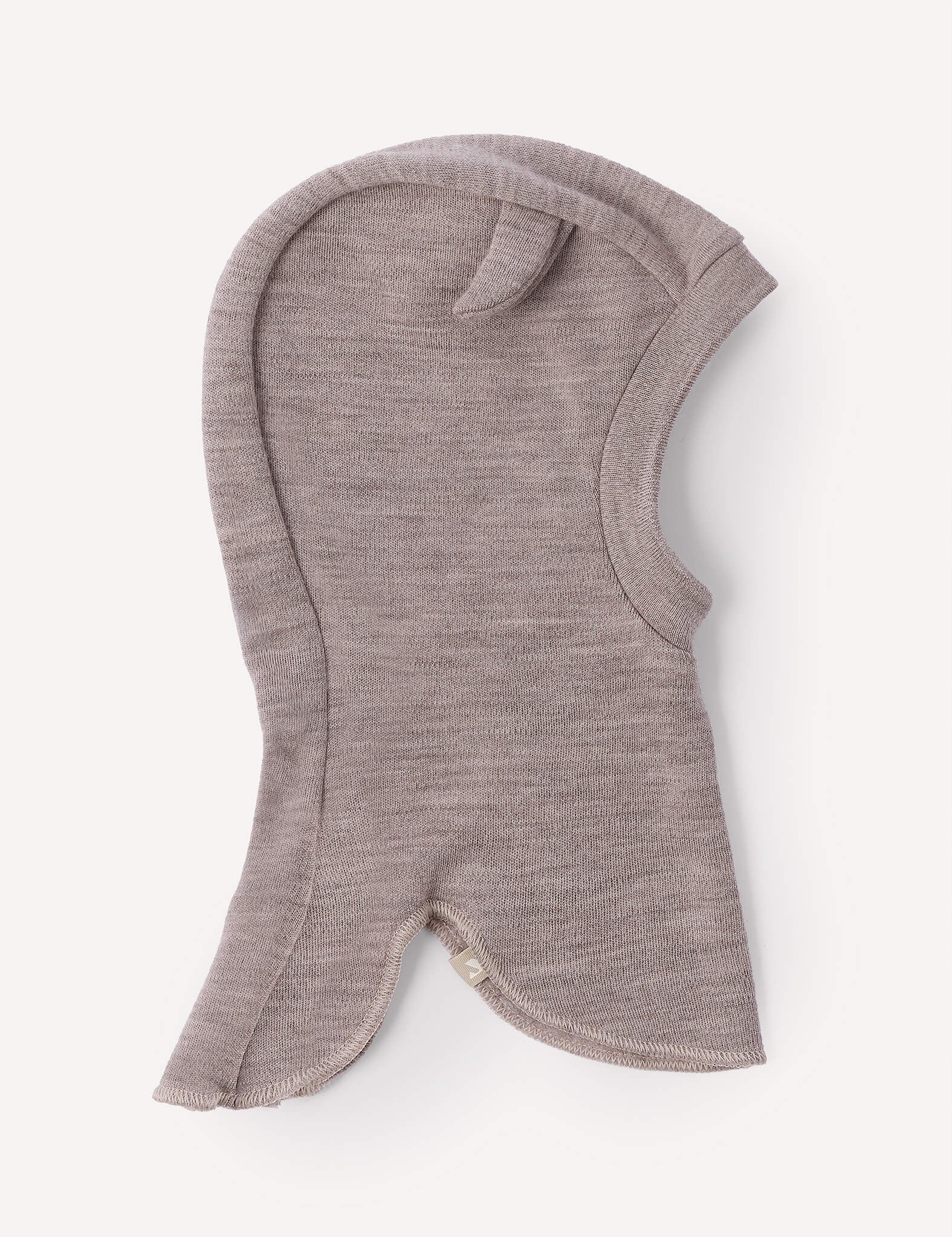 The Balaclava – Merino Baby AirWool in Beige Melange is a soft, knit merino wool balaclava for children, featuring a single ear-like detail on top and a face opening. This breathable headwear ensures lasting comfort and warmth throughout the day.