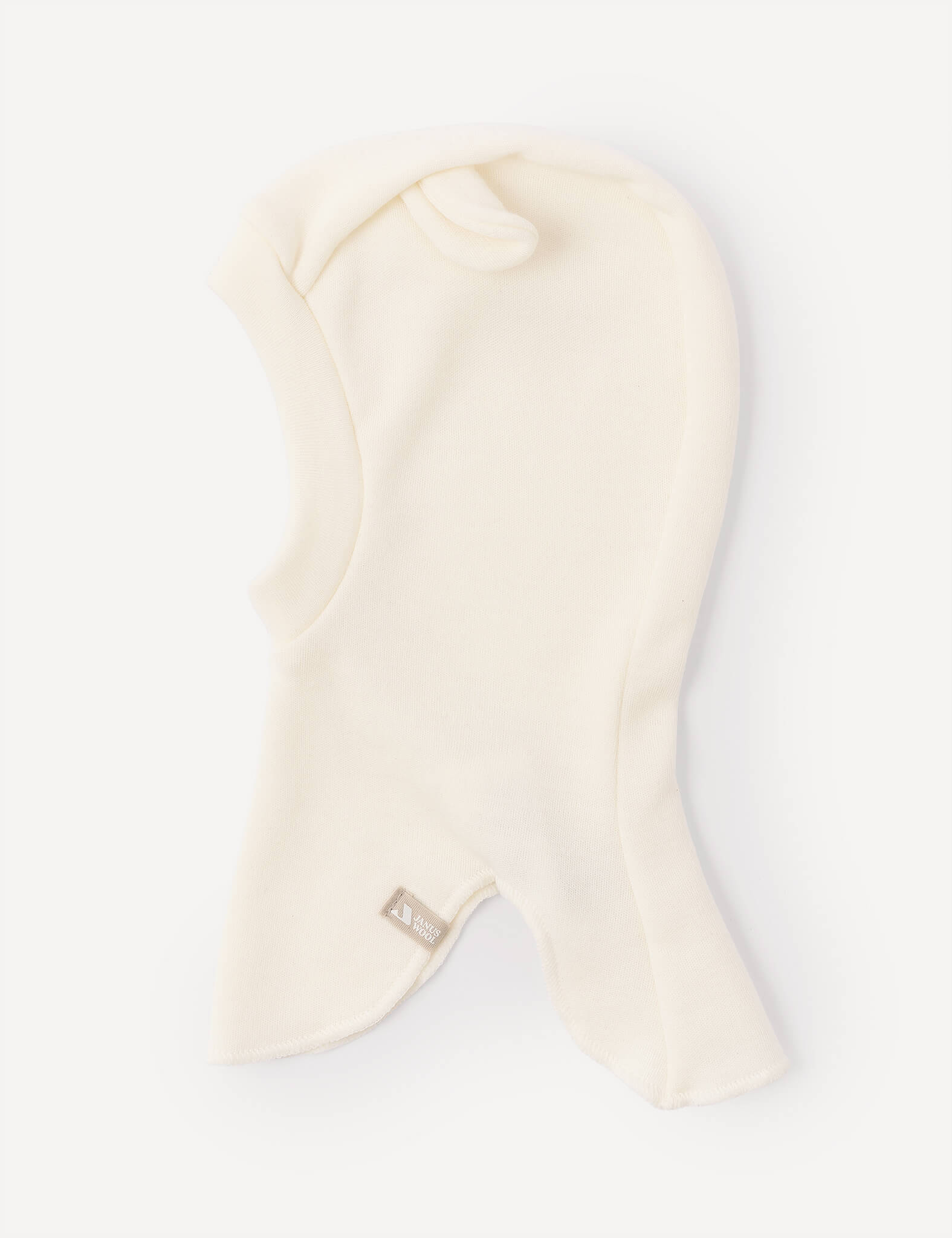 The Balaclava – Merino Baby AirWool is a cream-colored, fleece headwear featuring a small fabric tag at the front. Displayed on a plain white background, this breathable balaclava provides added comfort with its AirWool insulation.