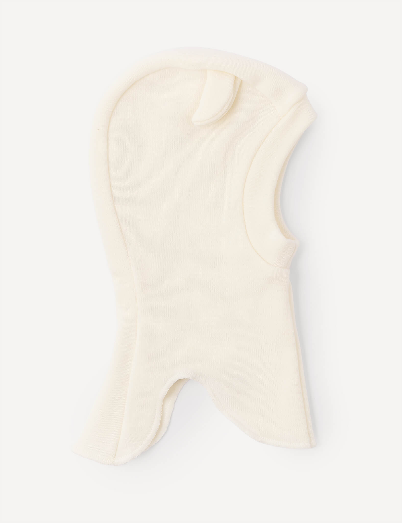 A marshmallow-colored Balaclava – Merino Baby AirWool for children, made from soft fleece merino wool, featuring a small ear-shaped detail on top and an opening for the face and neck.
