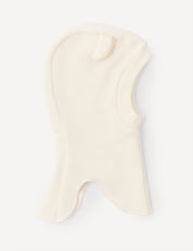 A marshmallow-colored Balaclava – Merino Baby AirWool for children, made from soft fleece merino wool, featuring a small ear-shaped detail on top and an opening for the face and neck.