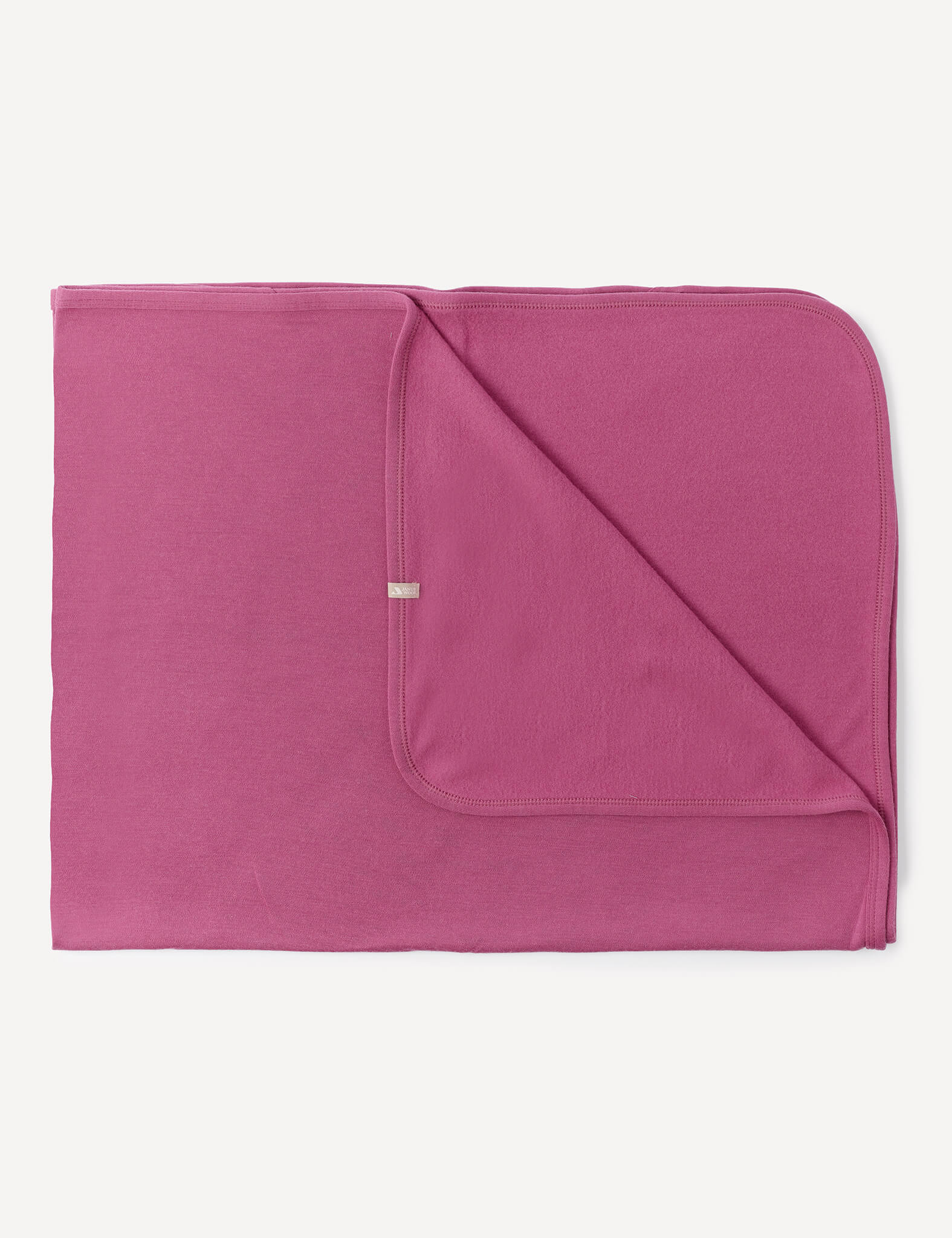 A folded Blanket – Merino Baby AirWool in Hawthorn Rose with rounded edges, displaying both the front and back sides, lying flat on a white background.