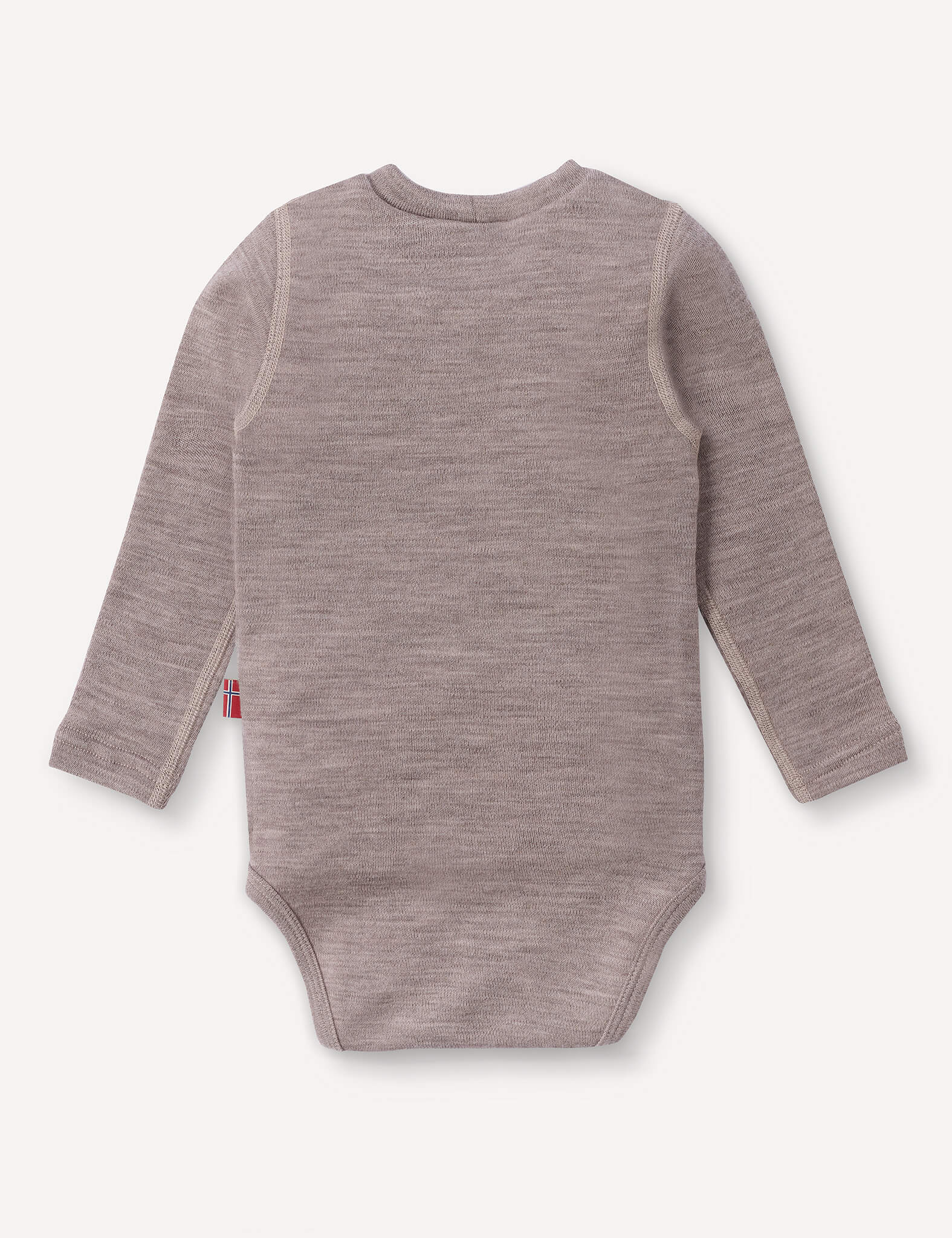 A long-sleeve, light brown Body – Merino Baby AirWool onesie is shown from the back against a plain white background. A small fabric tag with a striped design is visible on the left side seam, emphasizing its breathable comfort.