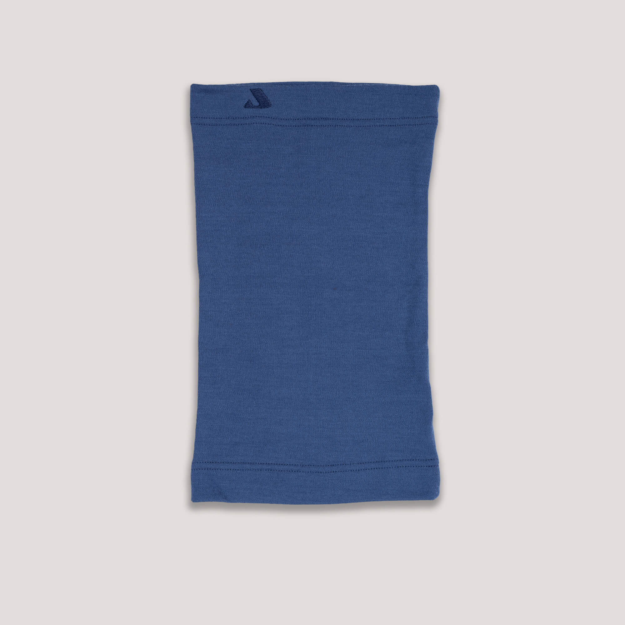 The Neck Warmer Merino – AirWool 260 in blue is laid flat on a light background, displaying simple stitching along the top and bottom edges to provide extra warmth.
