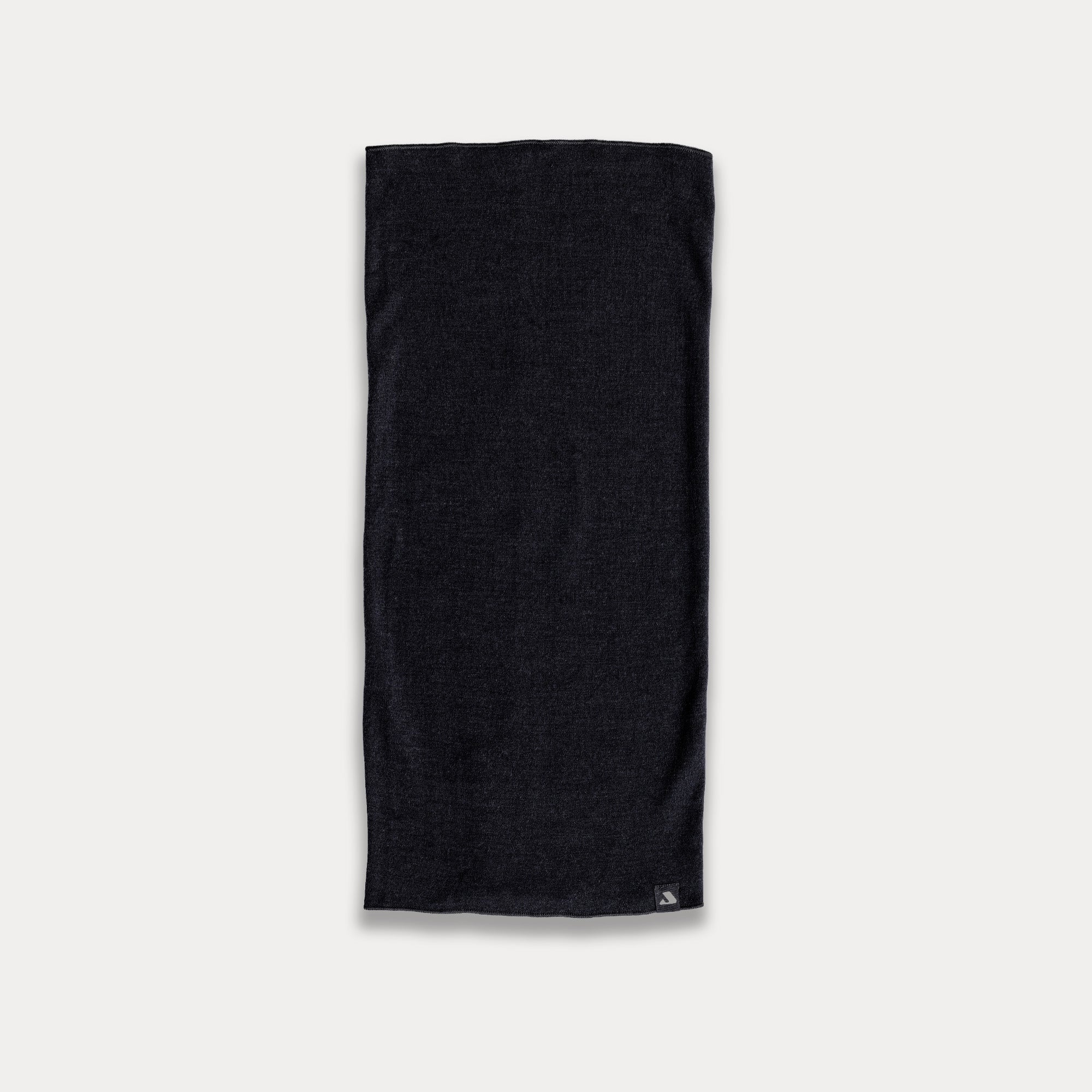 A Headover - Norse Merino 220, a black rectangular insulating merino wool towel, is laid flat on a plain white background with a small tag visible in one corner.