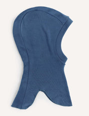 An Ensign Blue Balaclava – Merino Kids AirWool, featuring a hood-shaped design made from soft fabric, is shown laid flat on a light surface with a rounded top and flared, pointed bottom edges.