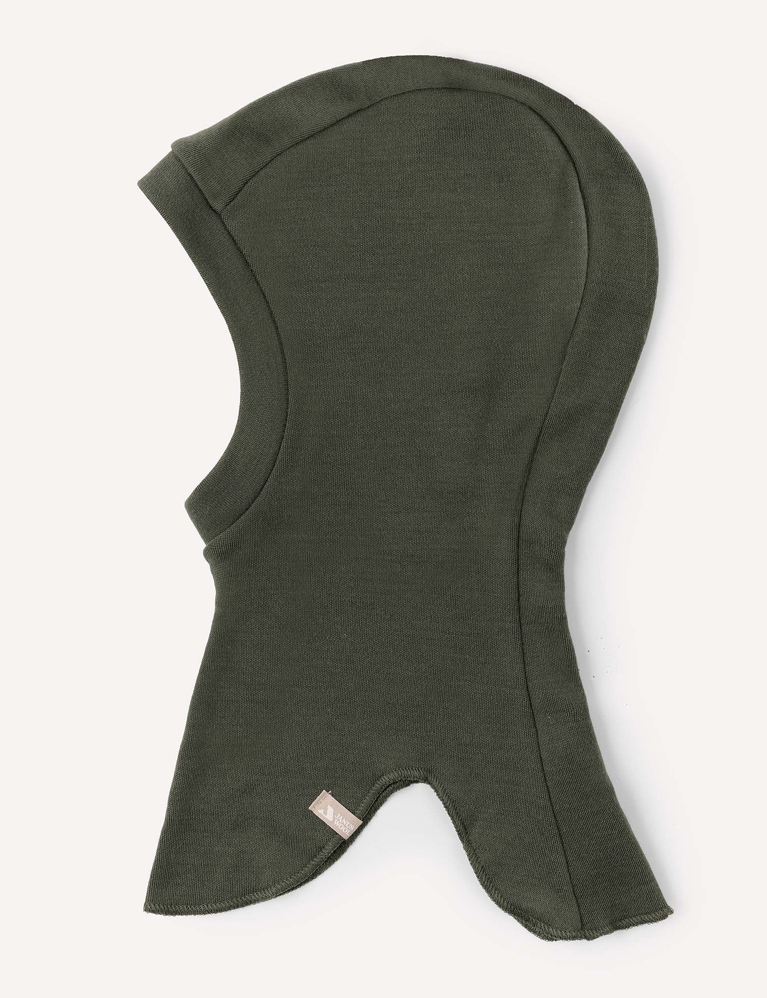 A warm balaclava in dark olive green, made from soft Merino Kids AirWool fabric, designed to cover the head, neck, and upper shoulders, and featuring a small fabric tag near the bottom edge.