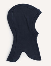 The Balaclava – Merino Kids AirWool in navy is crafted from soft merino wool. Displayed on a plain white background, it features a rounded top and a flared bottom for added neck coverage, ensuring warmth and comfort.