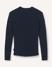 The Crewneck – Merino Kids Classic Rib, a long-sleeve dark navy blue ribbed wool jersey shirt, is shown from the back laid flat on a light background.