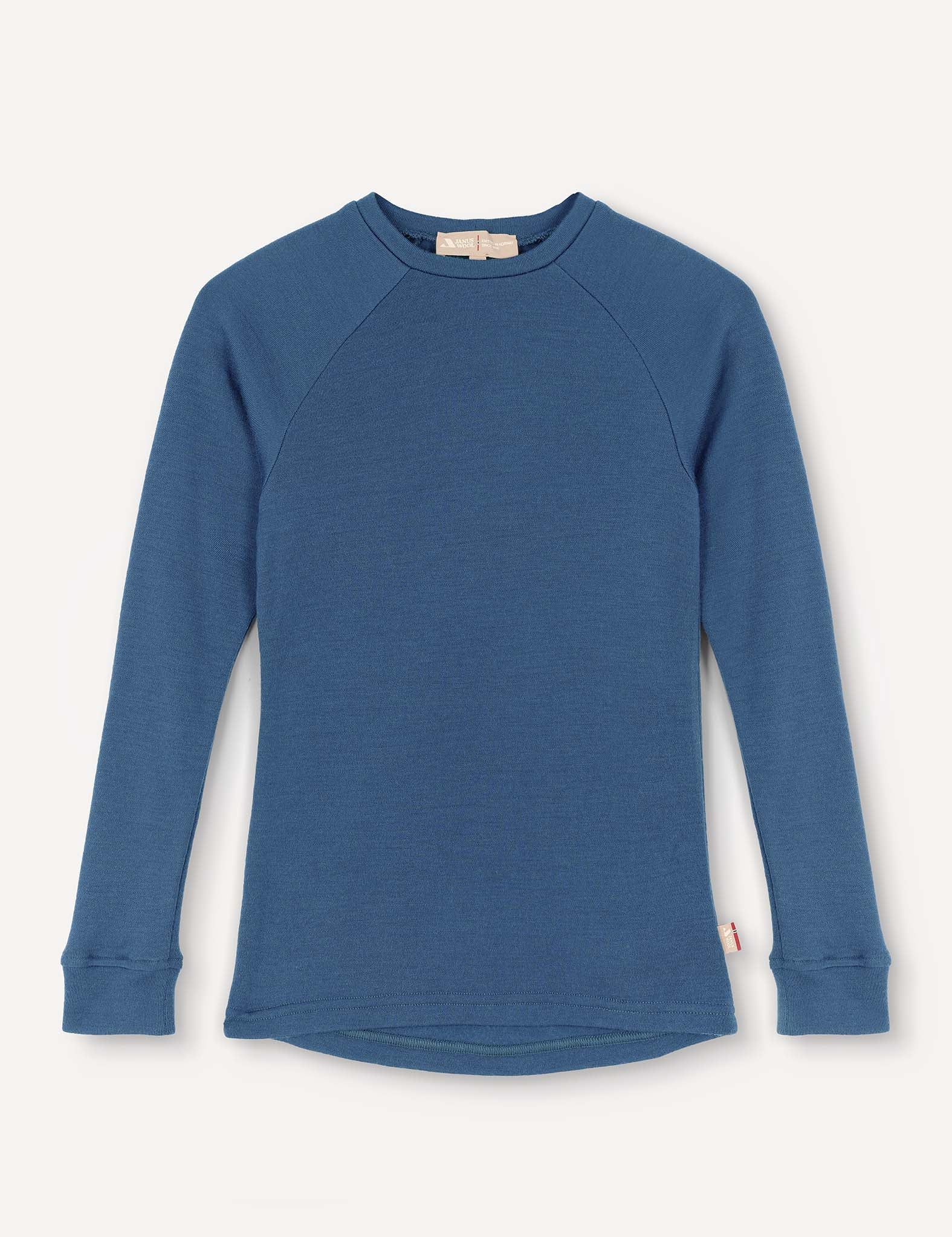 A Crewneck – Merino Kids AirWool shirt in Ensign Blue is laid flat on a white background. Made from soft merino wool, it features long sleeves, ribbed cuffs, and a slightly curved hem.