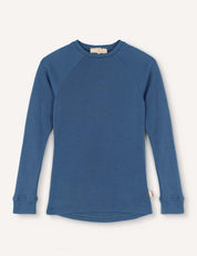 A Crewneck – Merino Kids AirWool shirt in Ensign Blue is laid flat on a white background. Made from soft merino wool, it features long sleeves, ribbed cuffs, and a slightly curved hem.