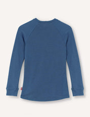 A blue Crewneck – Merino Kids AirWool long-sleeve jersey is laid flat with the back side facing up, highlighting its simple stitching and cuffed sleeves. Crafted from soft merino wool, it combines comfort with style.