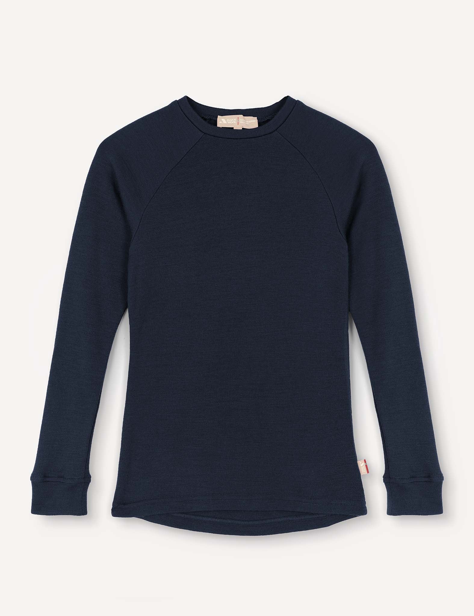 A navy Crewneck – Merino Kids AirWool long-sleeve shirt, featuring raglan sleeves, ribbed cuffs, and a small tag at the side hem, is displayed on a plain light background.