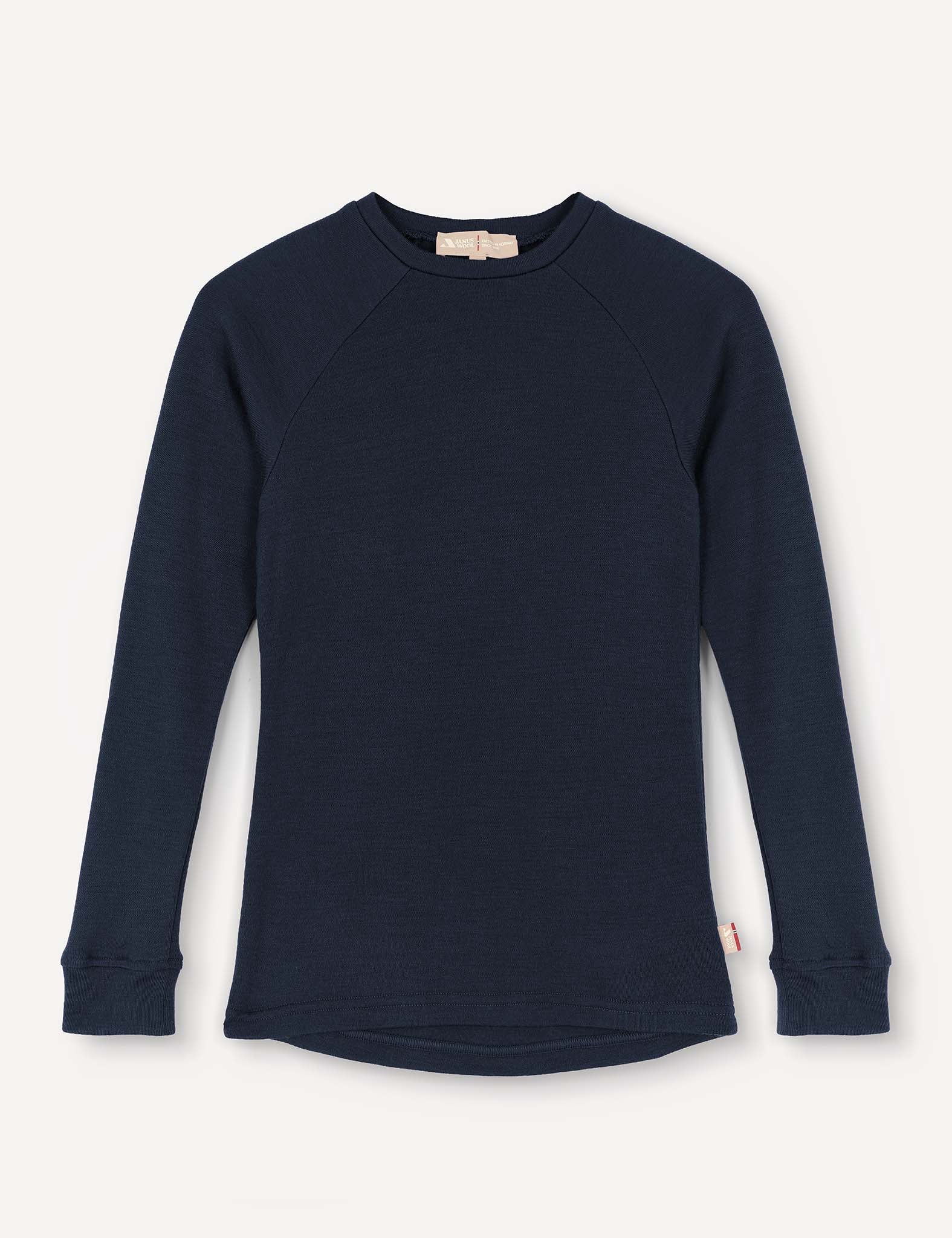 A navy Crewneck – Merino Kids AirWool long-sleeve shirt, featuring raglan sleeves, ribbed cuffs, and a small tag at the side hem, is displayed on a plain light background.