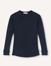 A navy Crewneck – Merino Kids AirWool long-sleeve shirt, featuring raglan sleeves, ribbed cuffs, and a small tag at the side hem, is displayed on a plain light background.