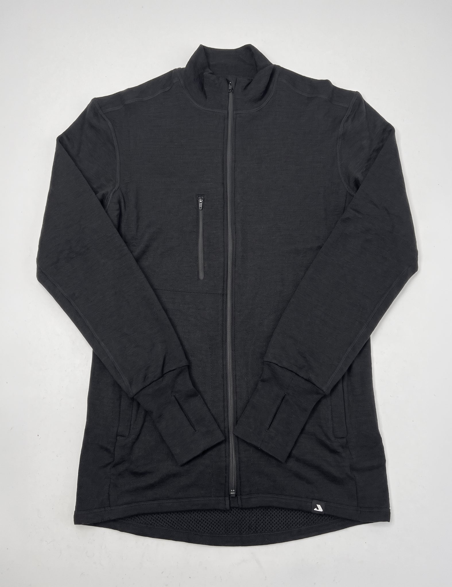 The Double Layer Jacket - Norse Merino Unisex is a black merino wool jacket featuring long sleeves with thumb holes at the cuffs and a zippered chest pocket on the left side, shown laid flat on a white background.
