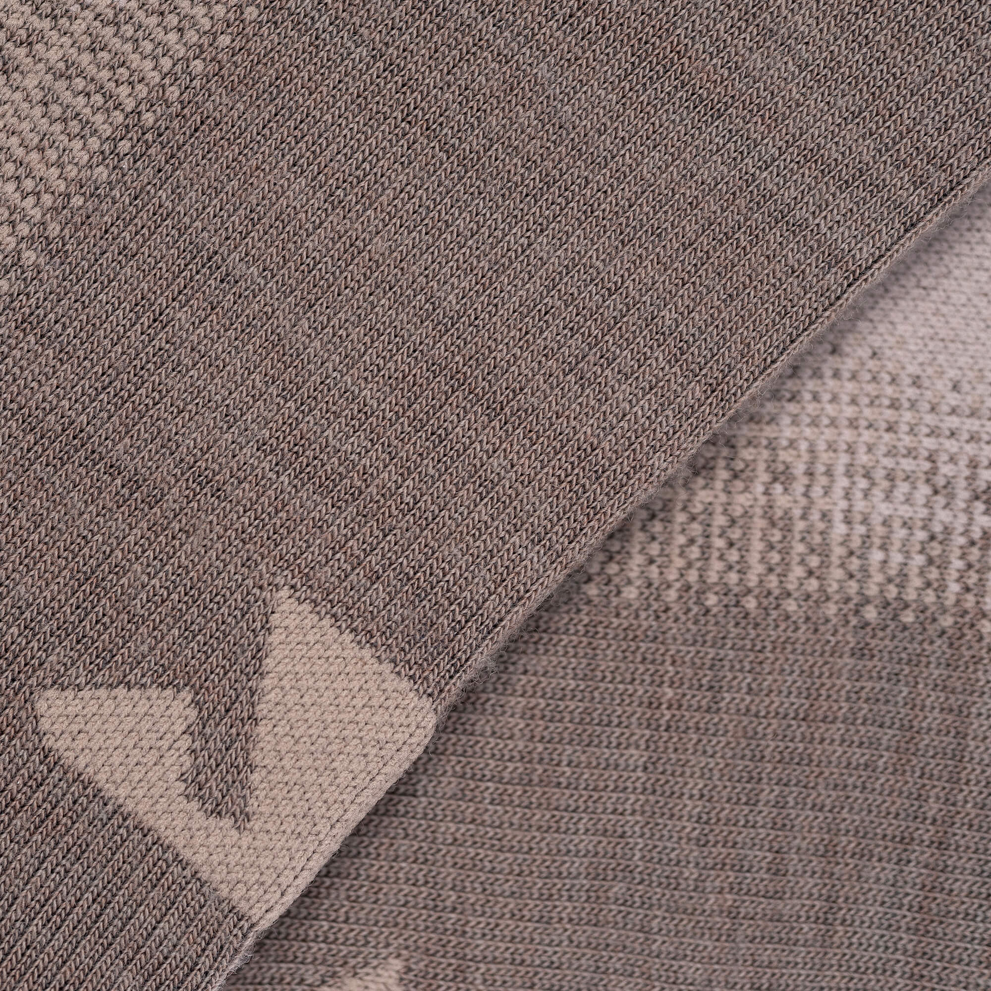 Close-up of brown and beige knitted fabric with a zigzag pattern, showing the soft texture and comfort of Socks Merino – Hiking, perfect for your next outdoor adventure.