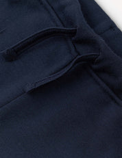 Close-up of the Sweatpants – Merino Kids AirWool in navy blue, featuring a fabric drawstring and a stitched waistband.
