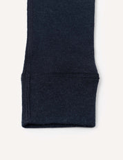 Close-up of the bottom cuff of a dark navy blue knit sleeve, likely from the Leggings – Merino Kids Classic Rib, featuring elastic ribbed fabric and visible stitching details.