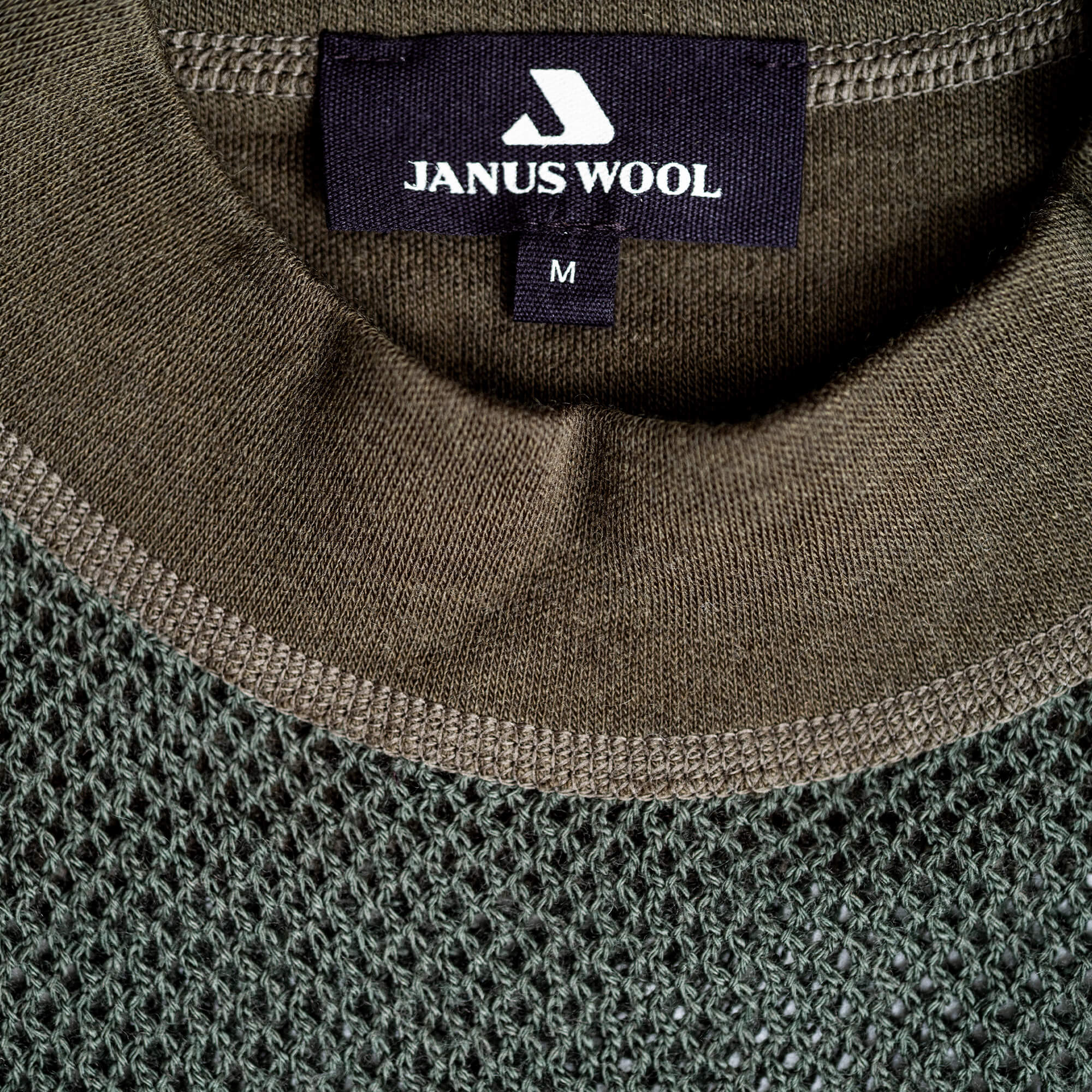 Close-up of Janus Wool green merino mesh jersey with details of crewneck