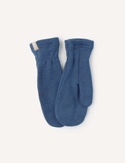 A pair of Mittens – Merino Kids AirWool in Ensign Blue is laid flat on a light background, featuring a small beige tag on the cuff of one mitten.