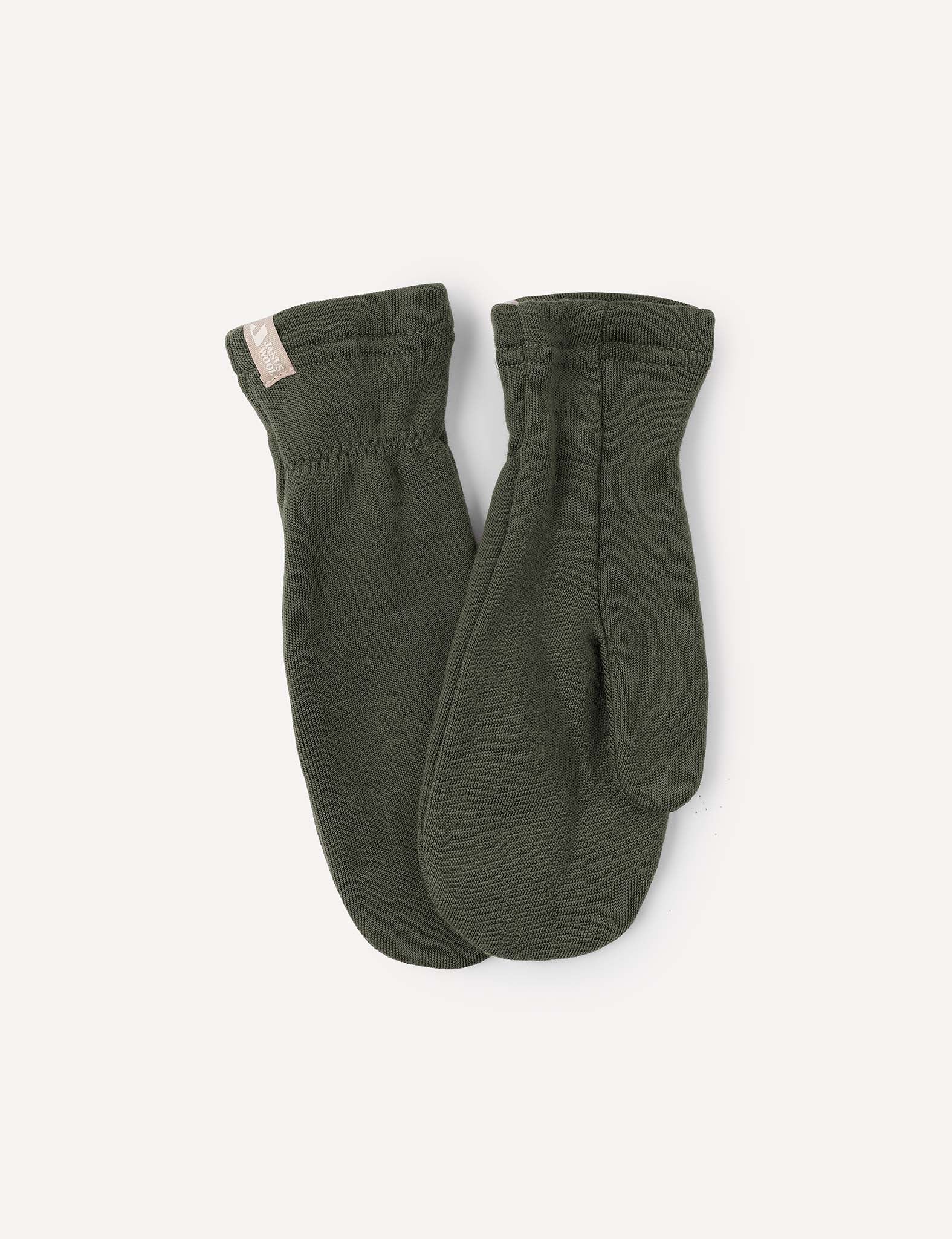 A pair of Forest Night Mittens – Merino Kids AirWool is laid flat on a light background. These warm merino wool mittens feature a simple design with ribbed cuffs and a small beige fabric tag on one cuff.