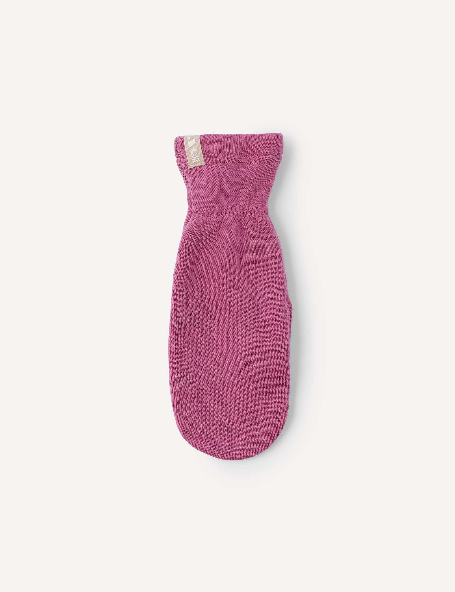 A single Merino Kids AirWool mitten in pink is displayed against a plain white background, shown palm side down with a small beige tag near the cuff.