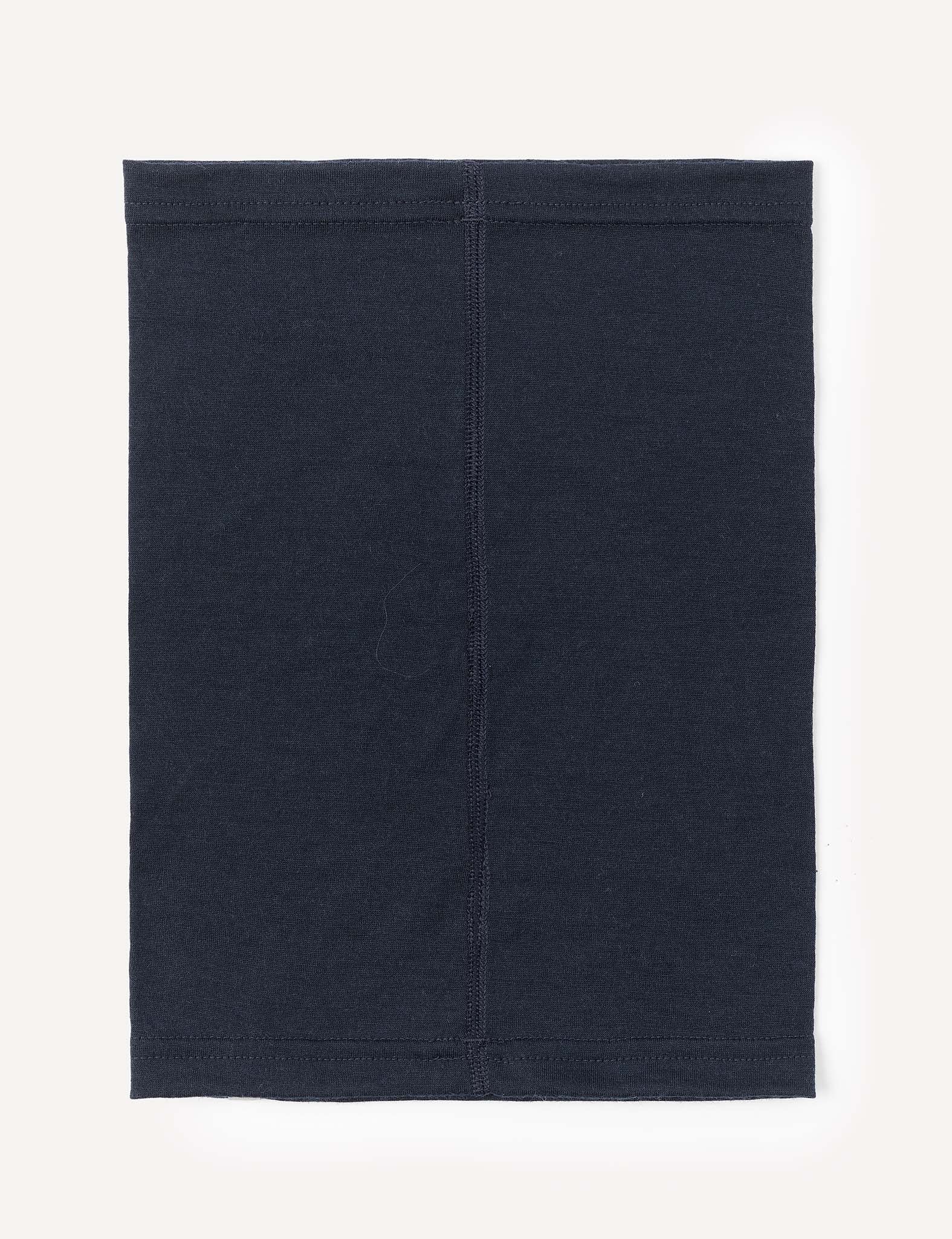 A rectangular black Merino Kids Light Neckwarmer made from merino wool, featuring visible stitching down the middle, is laid flat on a light background.