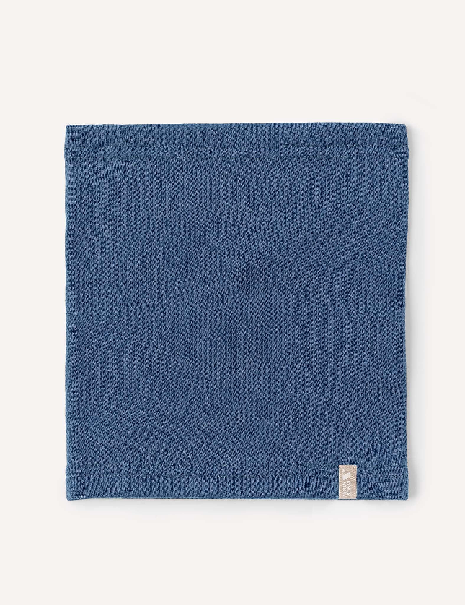 A flat, square-shaped blue Neckwarmer – Merino Kids AirWool made of wool, featuring a small beige tag on the bottom right corner, displayed against a plain white background.